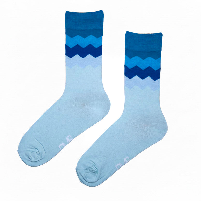 Pair of blue gradient socks with zigzag pattern on a white background